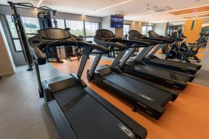 a row of tread machines in a gym at Intercity Tatuapé in Sao Paulo