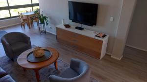 a living room with a flat screen tv and furniture at Superb accommodation in Stilbaai in Stilbaai