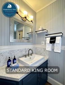 a bathroom with a sink and a mirror at Harborage Inn on the Oceanfront in Boothbay Harbor