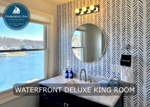 a bathroom with a mirror and a sink at Harborage Inn on the Oceanfront in Boothbay Harbor