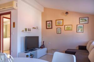 a living room with a couch and a flat screen tv at Isola Bella in Korčula