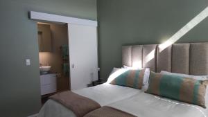 a bedroom with a bed and a bathroom with a sink at Superb accommodation in Stilbaai in Stilbaai