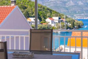 a balcony with a table and a view of the water at Isola Bella in Korčula
