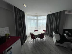 a kitchen and living room with a table and chairs at SA Apartments! Sea View 2bd Flat in Alanya