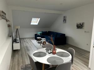 a living room with a table and a couch at Ilidza Blue Nest in Sarajevo +10 photos