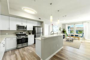 a kitchen with white cabinets and a counter top at Designer Apt with Jacuzzi, Pool & Mountain Views in Sparks
