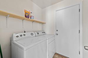 a white laundry room with a washer and dryer at Delightful 4BR Home Nr Downtown Reno w Fireplace in Reno