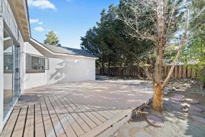 a patio with a tree next to a house at Delightful 4BR Home Nr Downtown Reno w Fireplace in Reno