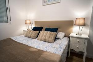 a bedroom with a bed with two lamps on it at Apartament Glamour La Mata in Torrevieja +26 photos
