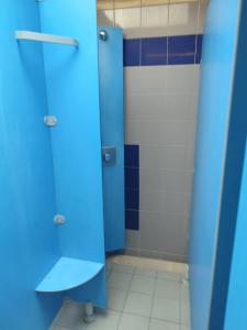 a blue bathroom with a toilet and a blue stall at voilier Cap d'Agde in Cap d'Agde