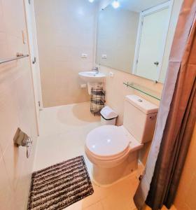 a bathroom with a toilet and a sink at Sonne & Strand AZURE NORTH PAMPANGA in San Fernando