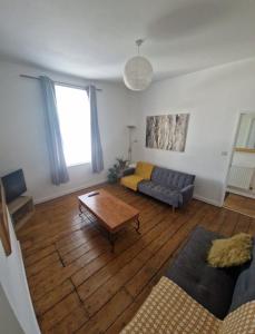 a living room with a couch and a coffee table at 13 Grosvenor House, in Bristol