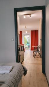 a bedroom with a bed and a room with a table at Green Terrace Family Apartment in Wrocław