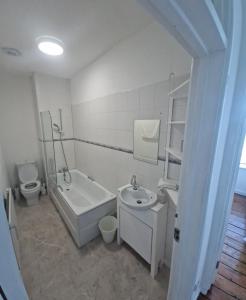 a bathroom with a sink and a toilet and a bath tub at 13 Grosvenor House, in Bristol