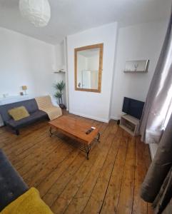 a living room with a couch and a coffee table at 13 Grosvenor House, in Bristol