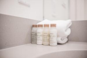 three bottles of lotion sitting on top of a sink at Lake Placid Lodge by Outpost Whistler in Whistler +35 photos