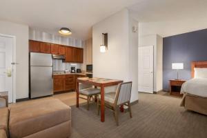 a kitchen and living room with a table and a bed at Residence Inn Baltimore White Marsh in Baltimore