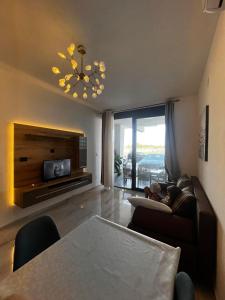 a living room with a couch and a chandelier at Sea Star Apartments in Ulcinj