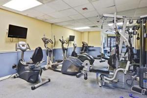 a gym with treadmills and exercise bikes in a room at Amazing Studio on Daytona Beach in Daytona Beach