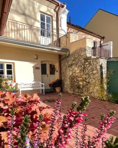 a house with pink flowers in front of it at Apartmány Bašta & Wellness in Sušice