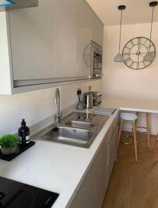 a kitchen with a sink and a counter top at Tenby hideaway - by the beaches in Tenby