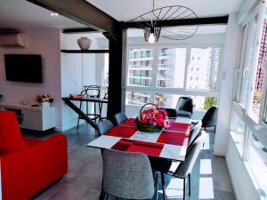 a living room with a table and a red couch at CASA MI LOLA in Benidorm