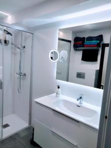 a white bathroom with a sink and a shower at CASA MI LOLA in Benidorm +33 photos