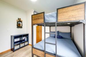 a bedroom with two bunk beds and a tv at Cadillac Vacation Rental on Lake Mitchell! in Cadillac