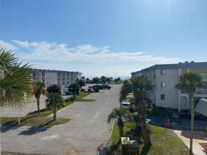 an empty street with palm trees and a building at Gulf Shores Plantation 4307 by ALBVR - New Upgraded Condo and Building - Great Amenities in Gulf Highlands
