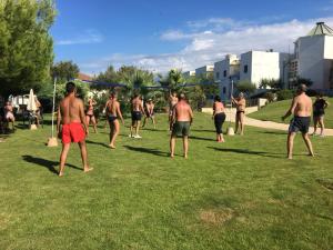 a group of shirtless men playing a game of baseball at Calanca Apulian Residence in Torre Santa Sabina