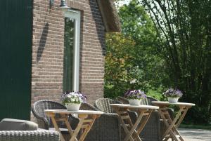 two tables with flowers on them on a patio at The Barnyard in Balinge