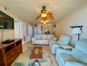 a living room with a couch and a table at Gulf Village 312 by ALBVR - Oversized balcony offers beautiful, unobstructed indirect views in Gulf Shores
