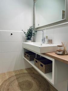 a bathroom with a white sink and a mirror at Myslbekova 17 in Jáma Jindřich