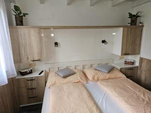2 Betten in einem kleinen Zimmer mit ermottermottermott in der Unterkunft chatka Tatralandia 433 Sofinka in Liptovský Mikuláš