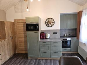 a kitchen with gray cabinets and a counter top at chatka Tatralandia 433 Sofinka in Liptovský Mikuláš