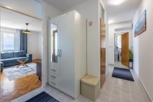a room with a hallway with a blue couch at Apartment Sea Star in Kastav