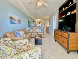 a living room with a couch and a flat screen tv at Island Royale P103 by ALBVR - Beachfront Penthouse living at its best - Gorgeous views in Gulf Shores