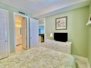 a bedroom with a bed and a flat screen tv at Island Royale P103 by ALBVR - Beachfront Penthouse living at its best - Gorgeous views in Gulf Shores