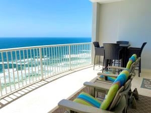a balcony with chairs and a view of the ocean at Island Royale P103 by ALBVR - Beachfront Penthouse living at its best - Gorgeous views in Gulf Shores