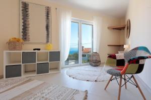 a living room with a view of the ocean at Villa Sunny Ičići- Apartment Sun in Ičići +118 photos