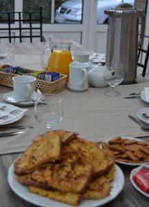 a table with a plate of toast and french fries at B&B Den Boomgaard Moorsel in Moorsel +16 photos