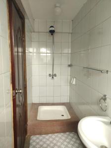 a bathroom with a shower and a sink and a toilet at Musundi Luxury Homes in Kakamega