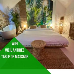 a bedroom with a large bed and a bath tub at Le Bali Safranier Vieil Antibes in Antibes