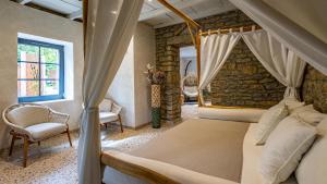 a bedroom with a bed and a stone wall at Maison Zugno Hôtel & Spa in Barretaine