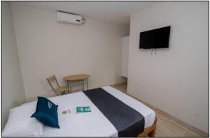 a bedroom with a bed and a flat screen tv at Nuevo Bamboo in Piura