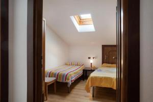 a bedroom with a bed and a table and a window at Atirano in Tirano