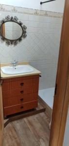 La salle de bains est pourvue d'un lavabo, d'un miroir et d'une baignoire. dans l'établissement Casa do Loureiro, 
