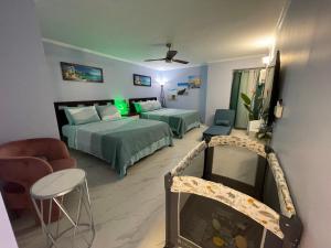 Amazing waikiki Beach condo 2Bed2Bath+free Parking في هونولولو: غرفة نوم بسريرين وصالة جلوس بها كنب