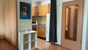 a kitchen with a door open to a kitchen with a counter at Kis-Celli apartman in Budapest