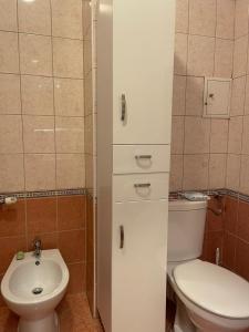 a bathroom with a toilet and a sink at Kis-Celli apartman in Budapest